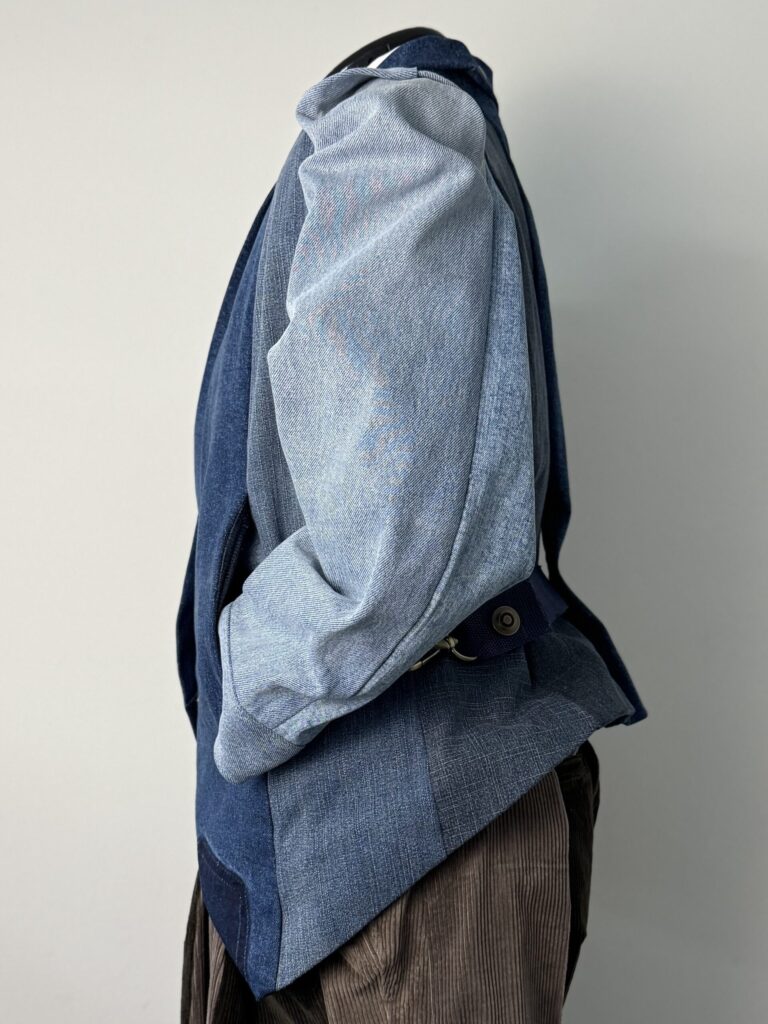 Four blues jeans blazer jacket upcycled from four preloved torn jeans. Side view