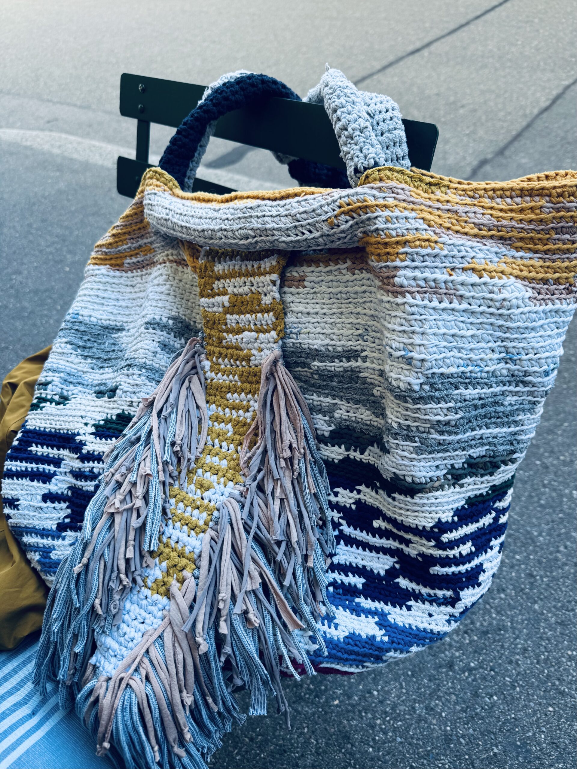 City Lights In The Water Bag- finished with all adaptations, placed nicely on a chair outside.